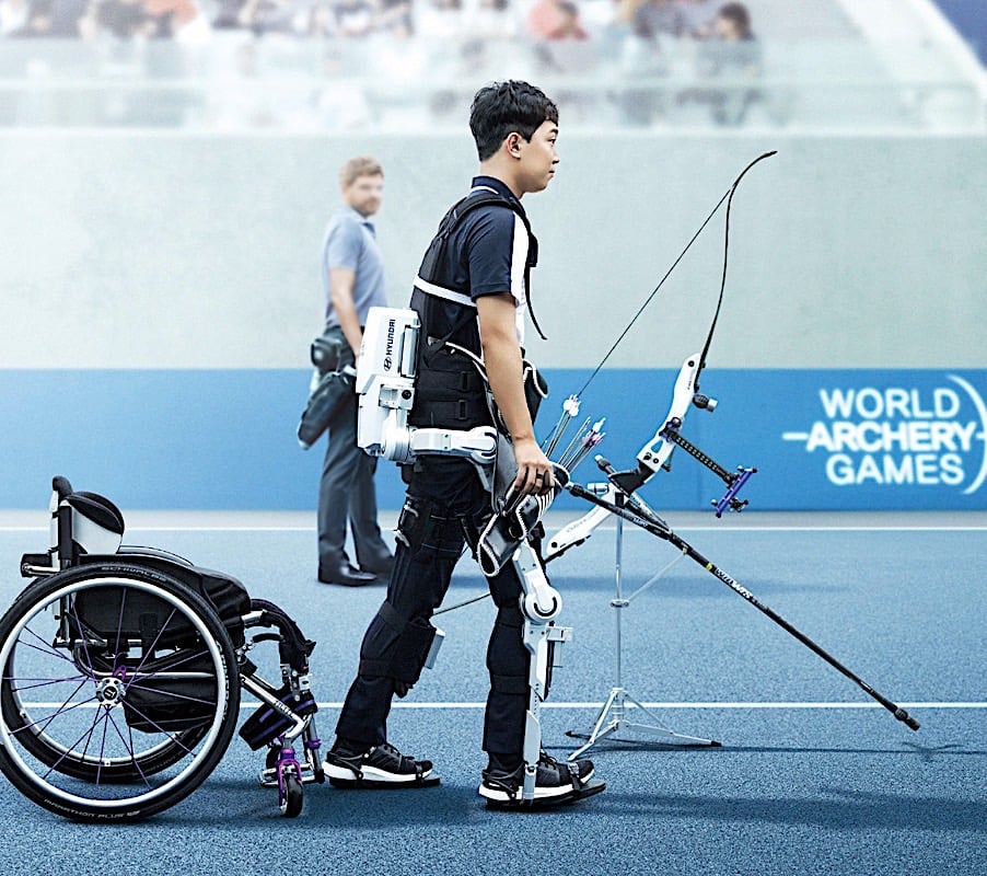 Hyundai demostrated the transformational power of the exoskeletal assist. here athlete-archer Park Jun Beon is assisted to stand by Hyundai's medical exoskeleton, demonstrating astonishing transformative benefits. Image courtesy Hyundai.