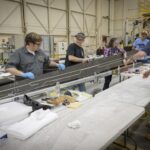 Lab technicians Phil Tofts, Chris McLain, and Jeff Howell and NASA engineers Erin Anderson and Richard Larson prepare the 15-foot Structural Wing Experiment Evaluating Truss-bracing model in the Flight Loads Laboratory at NASA’s Armstrong Flight Research Center in Edwards, California, on Thursday, Dec. 11, 2025. The model is part of NASA’s research to develop technologies for future ultra-efficient aircraft.  NASA/Christopher LC Clark